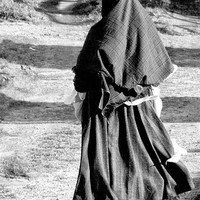 Buy canvas prints of Woman Walking Traditional Dress by Tim O'Brien