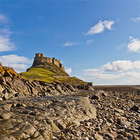 Buy canvas prints of Lindisfarne Castle viewed from the shoreline. by Kevin Tate