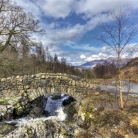 Buy canvas prints of Ashness Bridge towards Skidaw by Kevin Tate