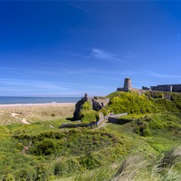 Buy canvas prints of Bamburgh castle and beach by Kevin Tate