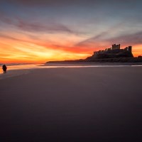 Buy canvas prints of Bamburgh Castle Sunrise - The Lone Photographer by Northeast Images