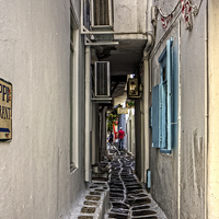 Buy canvas prints of Narrow Lane in Mykonos by Tom Gomez