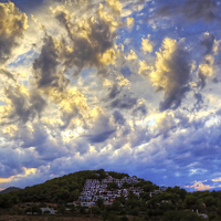 Buy canvas prints of Clouds over Cala Llonga by Tom Gomez