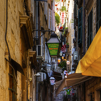 Buy canvas prints of Cafe in a Dubrovnik Alley by Tom Gomez