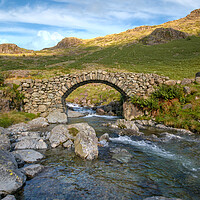 Buy canvas prints of lingcove bridge , pack horse bridge, lingcove beck river esk, eskdale, cumbria, lake district, mountains, mountain stream, rocky out crops, valley, no people, greenery, rural, countryside, uk, great britain, england, walking, outdoor , ancient , by Eddie John