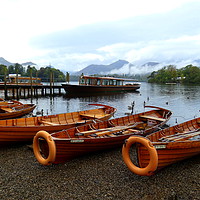 Buy canvas prints of Grey skies over Derwentwater Lake. by Lilian Marshall