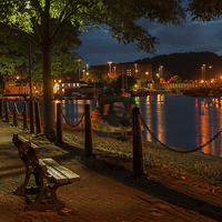 Buy canvas prints of  The bench on the docks. by John Morgan