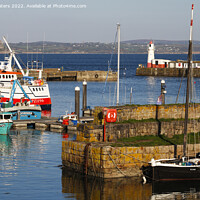 Buy canvas prints of Newlyn South Pier Lighthouse and St Michael's Mount by Terri Waters