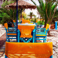 Buy canvas prints of Santorini Yellow Chairs by DEE- Diana Cosford