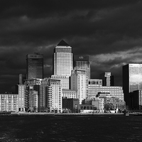 Buy canvas prints of Canary Wharf sunlit from the Thames B&W version by Gary Eason
