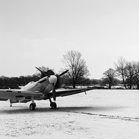 Buy canvas prints of Spitfires in the snow black and white version by Gary Eason