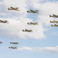 Buy canvas prints of Flying legends: massed Spitfires flypast by Gary Eason