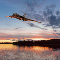Buy canvas prints of Vulcan low over a sunset lake by Gary Eason