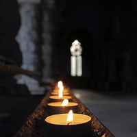 Buy canvas prints of St Conans Kirk - Prayers Candles (interior) by Maria Gaellman