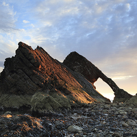 Buy canvas prints of Bow Fiddle Rock at Sunrise by Maria Gaellman