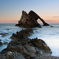Buy canvas prints of Bow Fiddle Rock at Sunset by Maria Gaellman