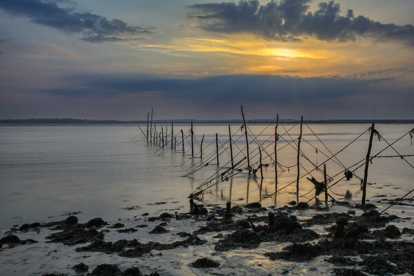 Fishing nets at Sunset Canvas Print by Derek Beattie