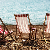 Buy canvas prints of Stripy Deckchairs Pebble Beach Sea and Sunshine by Natalie Kinnear