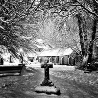 Buy canvas prints of Snow covered Graveyard and church by Doug Lohoar