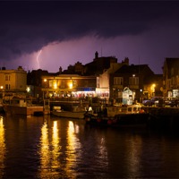Buy canvas prints of Lighting Across Weymouth Harbour by Paul Brewer