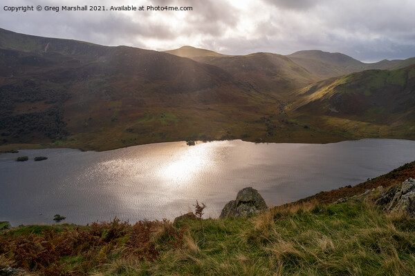 Sun breaks over icy looking Crummock Water from Rannerdale Knotts Picture Board by Greg Marshall
