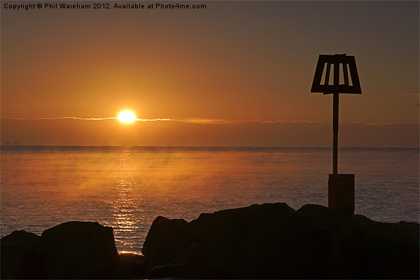 Sunrise over the breakwater Picture Board by Phil Wareham