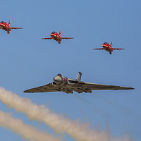 Buy canvas prints of  Avro Vulcan XH558 and the Red Arrows perform a fi by stuart bennett
