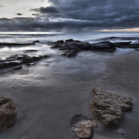 Buy canvas prints of Stormy Beach Sunset by Andy Anderson