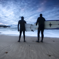 Buy canvas prints of Surfers at Dawn Boscombe Pier by Jennie Franklin