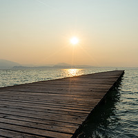 Buy canvas prints of Sunrise on Lake Garda by Ann Garrett