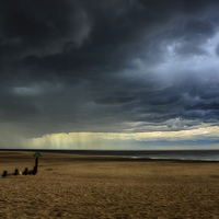Buy canvas prints of Storm clouds over Wells beach by Mark Bunning