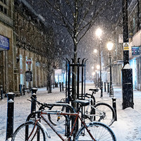 Buy canvas prints of  Cycles in the Snow, Cambridge Street, Harrogate by Paul M Baxter