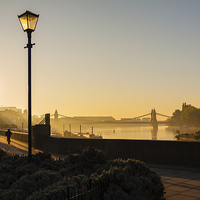 Buy canvas prints of  Early morning: Hammersmith Bridge, lone cyclist by Matthew Bruce