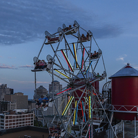 Buy canvas prints of  Ferris Wheel on top of skyscraper  by Philip Pound