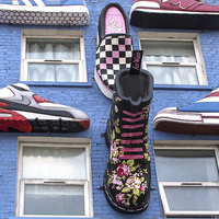 Buy canvas prints of  Boots and Trainers on a Blue Wall by Philip Pound
