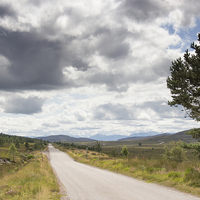 Buy canvas prints of  Clouds above remote Highland Road by Derek Corner