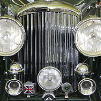 Buy canvas prints of  Headlight and badges on vintage Bentley by Derek Corner