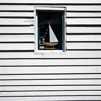 Buy canvas prints of Model Boat In A Window by Ian Lewis