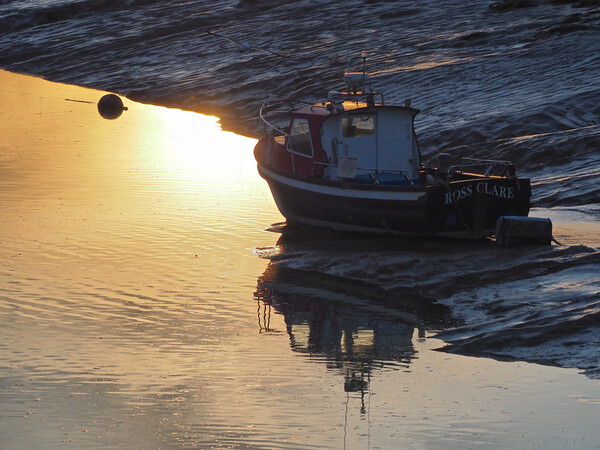Golden Sunset with boat in water at Clevedon harbour, Somerset. Picture Board by mark humpage