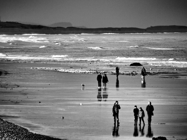 North Norfolk coast with people walking on beach black and white Picture Board by mark humpage