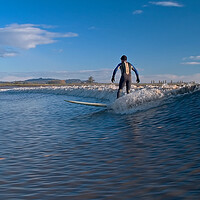 Buy canvas prints of Lone surfer riding a wave on the river Severn by mark humpage