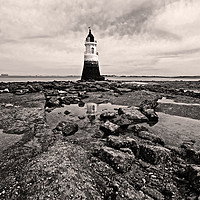 Buy canvas prints of Lighthouse on a rocky shore by David McCulloch