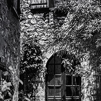 Buy canvas prints of A Shadowy alley in Saint Paul de Vence France by Maggie McCall