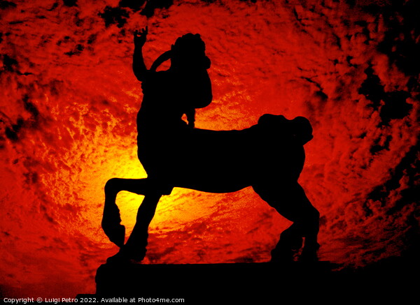 Sculpture of a Centaur against a red hot sky. Picture Board by Luigi Petro