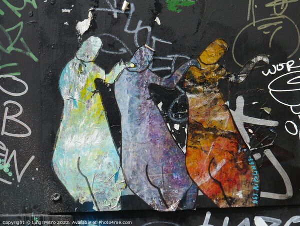 Graffiti depicting three figures standing next to each other. Picture Board by Luigi Petro