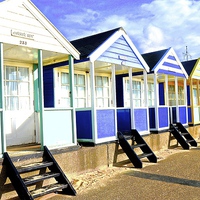 Buy canvas prints of  Southwold bright beach huts by Sue Bottomley