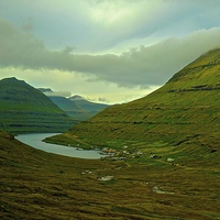 Buy canvas prints of  Mountains and small village in the Faroe Islands by Sue Bottomley