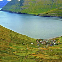 Buy canvas prints of  Mountains and small village in the Faroe Islands by Sue Bottomley