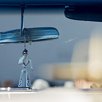 Buy canvas prints of Elvis figure hangs fom rear view mirror by Phil Crean