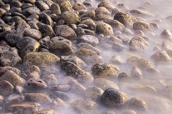 Misty rocks on the shore at dawn Picture Board by Phil Crean